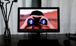 Photo of computer screen showing binoculars with Facebook's logo
